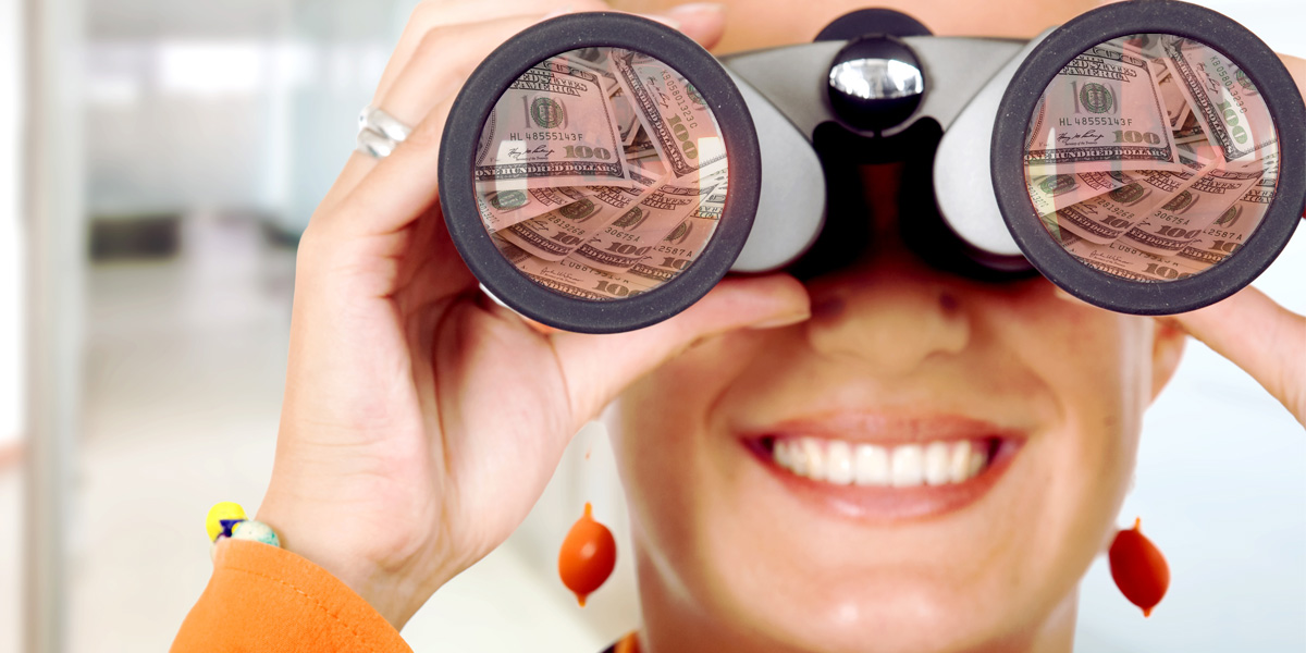 A woman looking through binoculars with money in the lenes