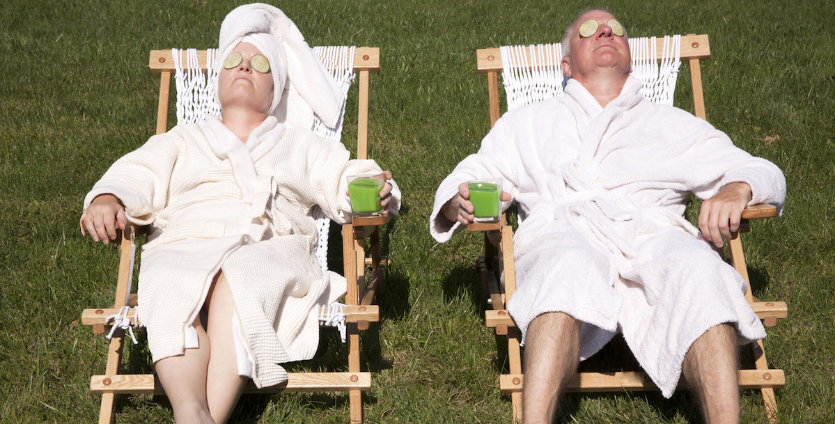 A mature couple detoxing during a do it yourself spa day in their backyard