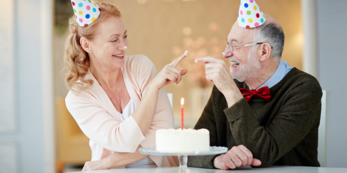 Two senior living residents celebrating a birthday with cake