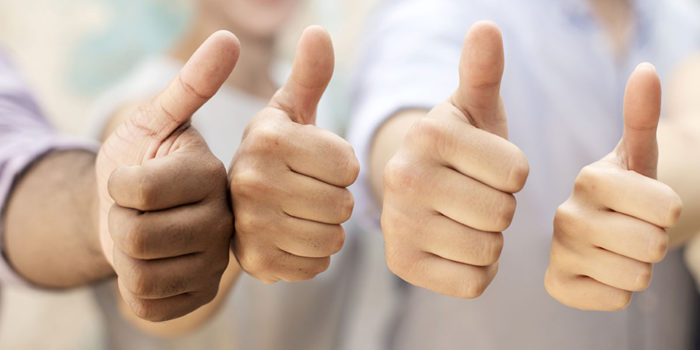 Four hands giving thumbs up in a row