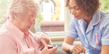 improve the resident experience | a senior care worker attends to an elderly woman