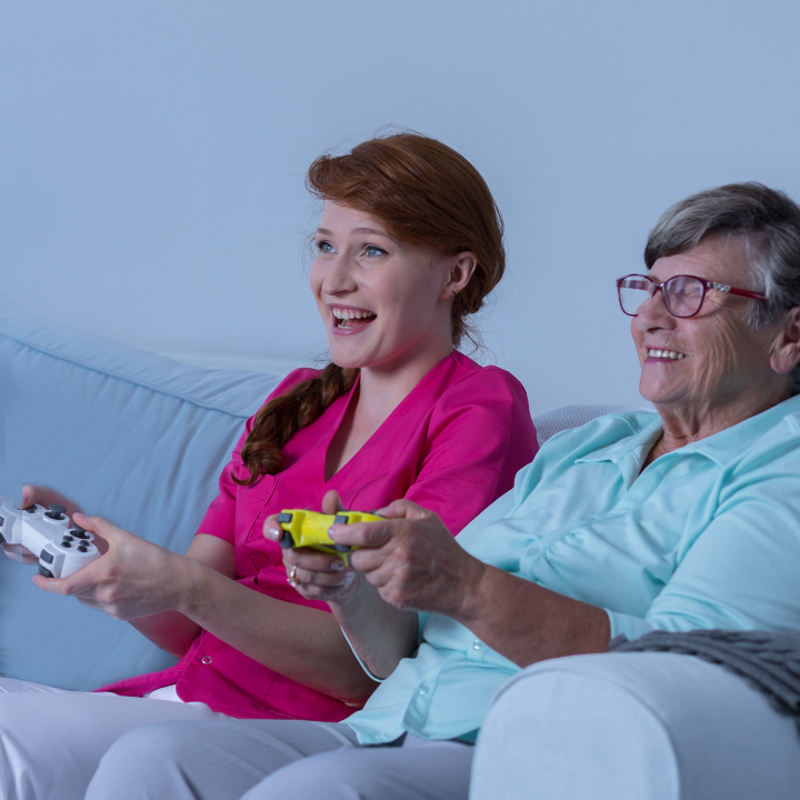 Female skilled nursing provider playing video games with a resident to provide a better resident experience
