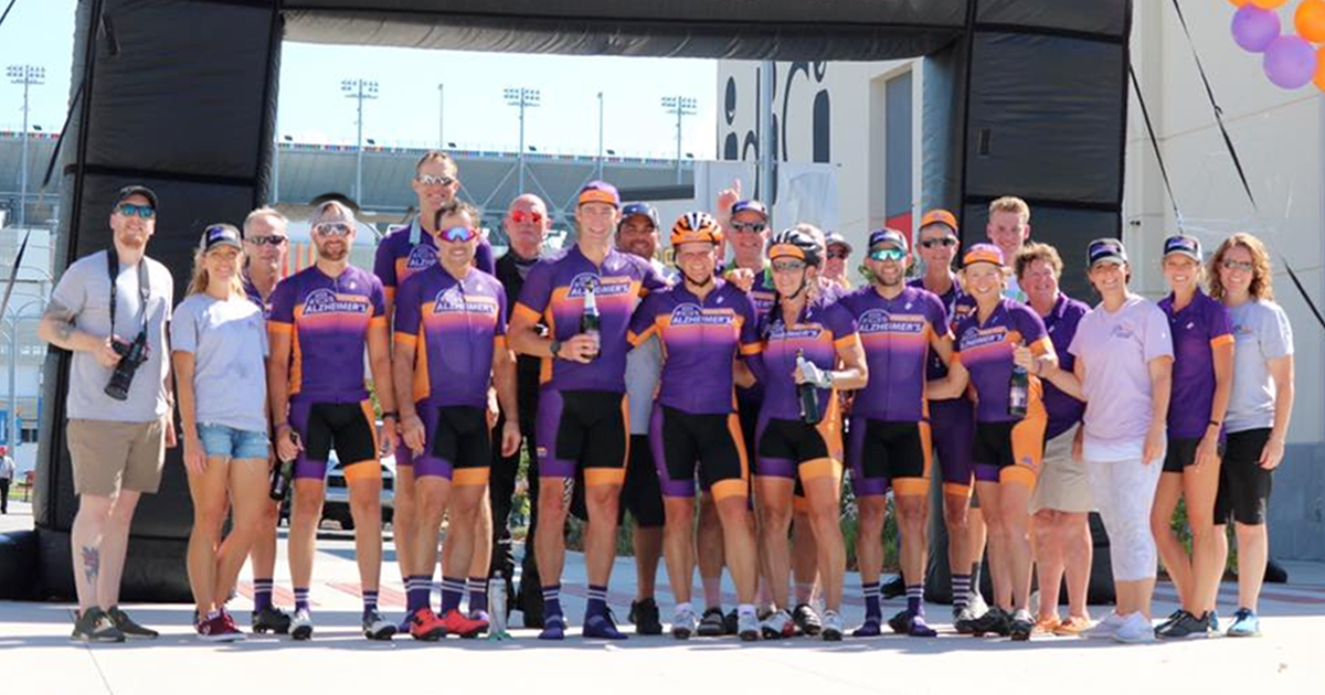 PointClickCare President Dave Wessinger smiles with a team of Pedal for Alzheimer's cyclists