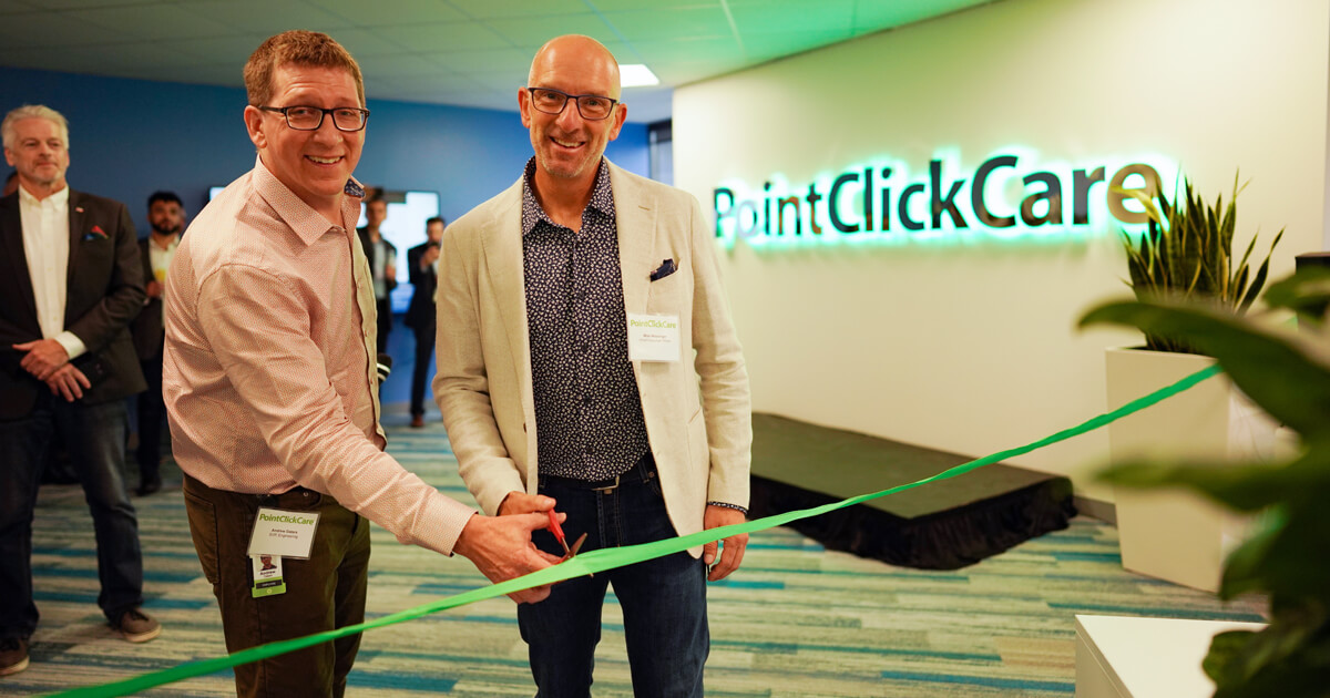 Mike Wessinger cutting the ribon at the opening of PointClickCare's new downtown office