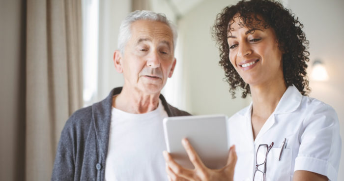 Linked Senior with caregiver on tablet