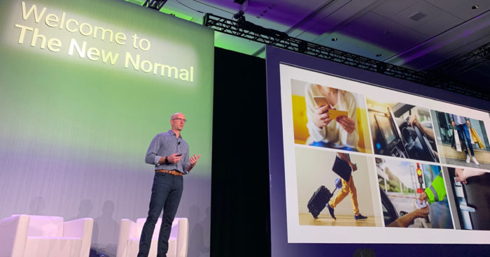 PointClickCare Founder and CEO Mike Wessinger stands on stage speaking to PointClickCare customers about the New Normal at SUMMIT 2019.