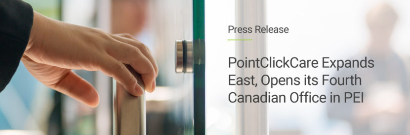 A hand opening the door of the new PointClickCare office in Charlottetown, Prince Edward Island