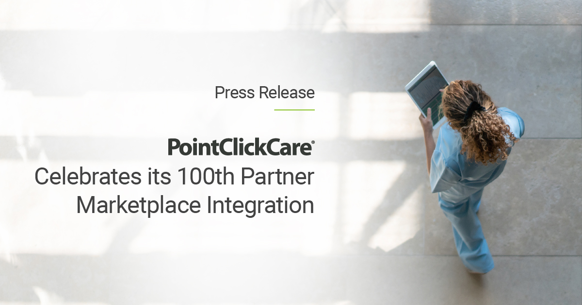 A nurse walking while using a table device reading about the 100th Partner Integration to the PointClickCare Marketplace