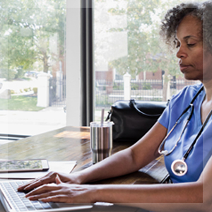 Female clinical nurse viewing Care Insights on a laptop device