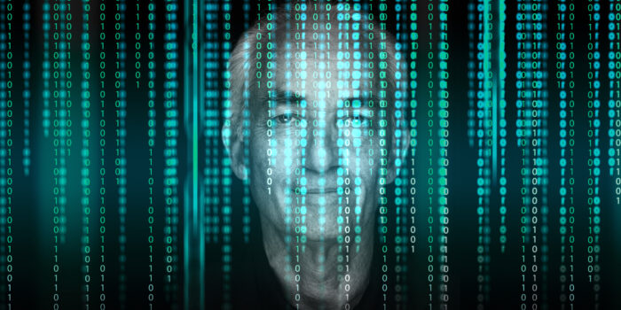 Close up of an elderly mans face with a graphic overlay of several lines of code all over the image