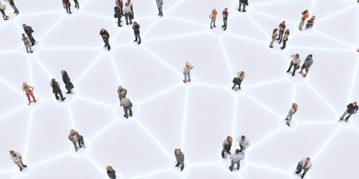 Clusters of people standing on illuminated connected circles depicting a network