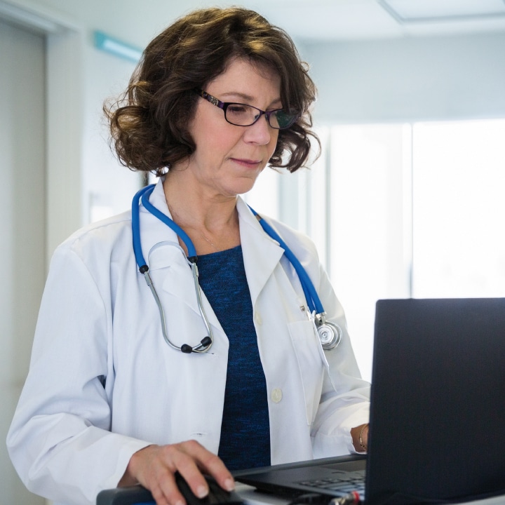 IPC Advanced Reporting Dr. reviewing information on laptop