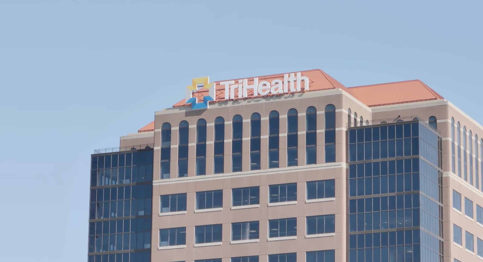 Outside of a TriHealth company building with the logo at the very top of the building
