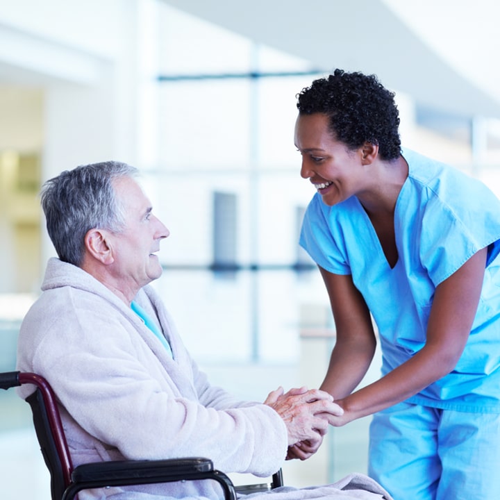 Nursing talking with resident on wheelchair
