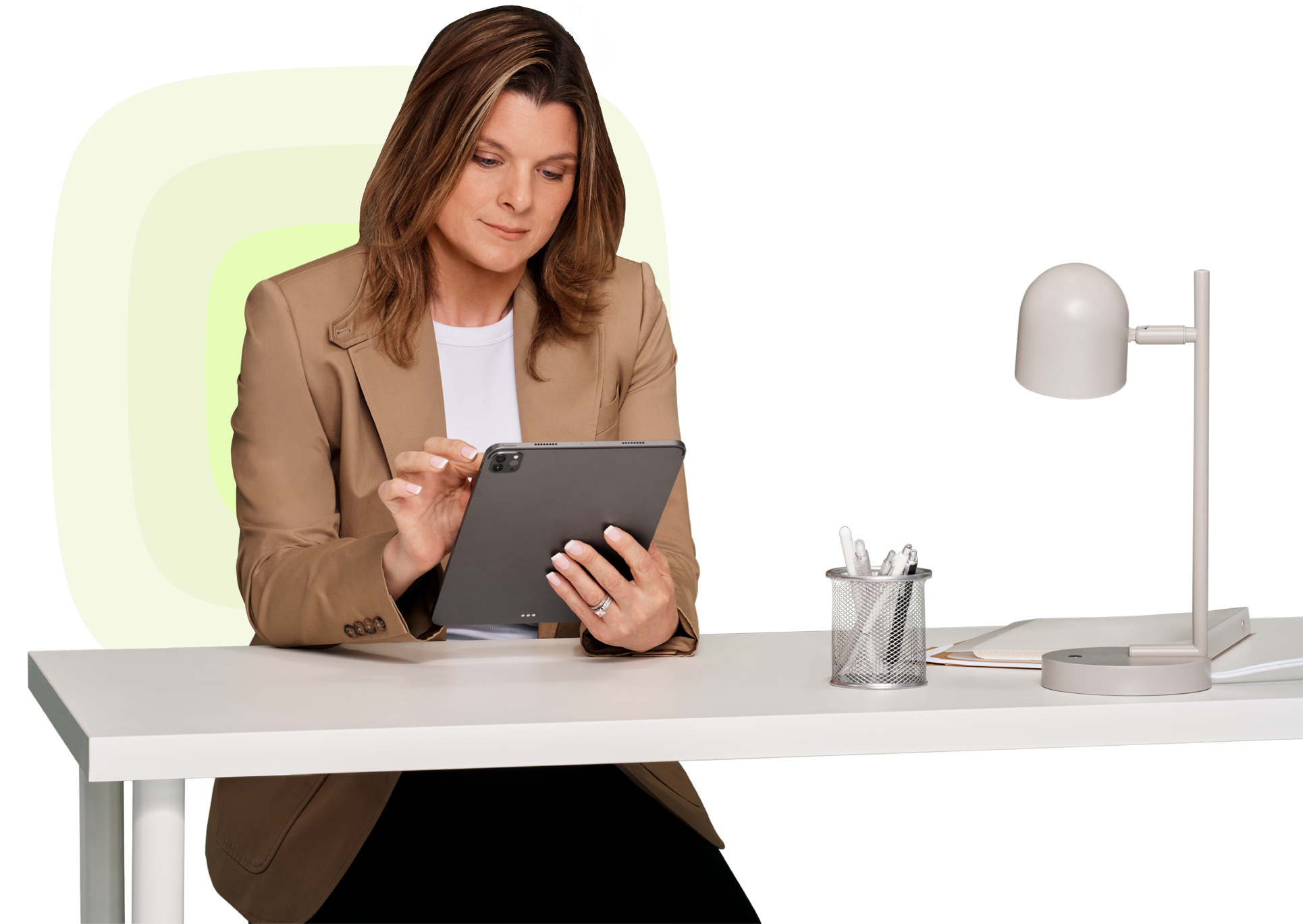 PointClickCare team member working on a tablet at her desk, reflecting the company’s focus on innovation and people-centered healthcare.