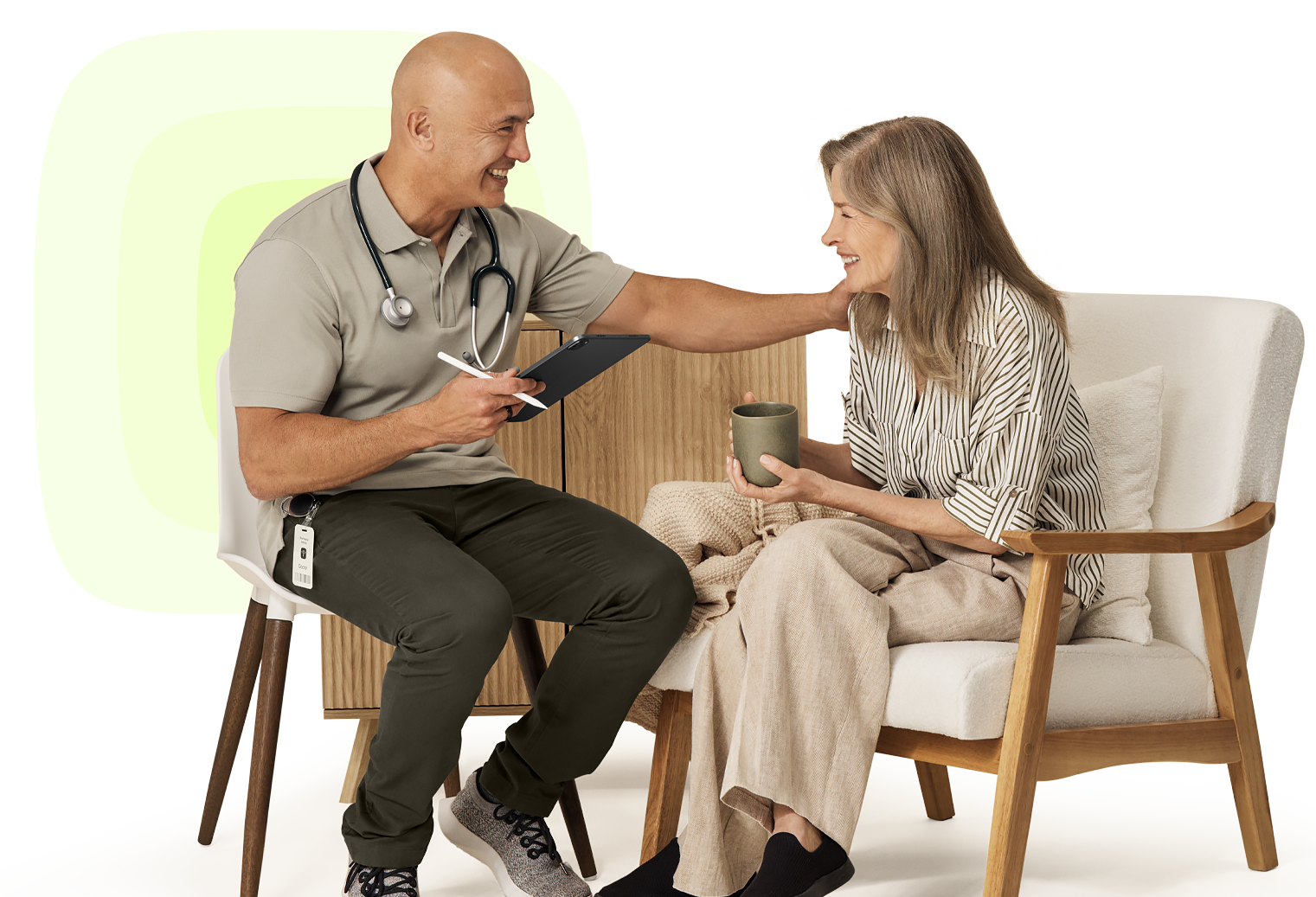 Healthcare provider using PointClickCare software on a tablet while supporting an older patient at home.